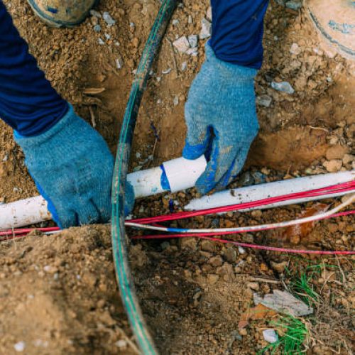 Plumber Hillcrest 3 Irrigation Landscaping Worker Installing PVC Pipe for a Sprinkler System in New Construction in the Midwest, Southern USA